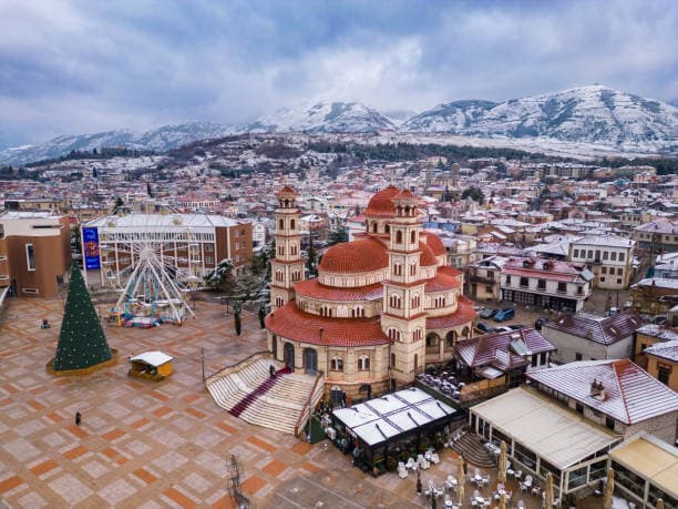 Modern apartment buildings and houses in Korçë  showcasing beautiful real estate properties