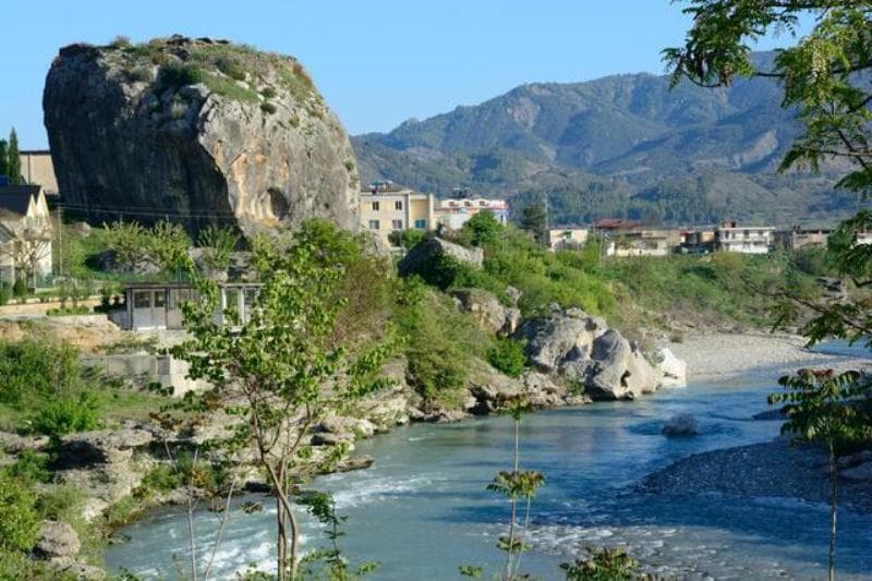 Modern apartment buildings and houses in Përmet  showcasing beautiful real estate properties