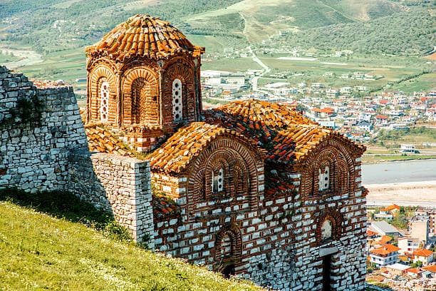 Modern apartment buildings and houses in Berat showcasing beautiful real estate properties