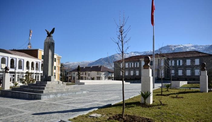 Modern apartment buildings and houses in Ersekë  showcasing beautiful real estate properties