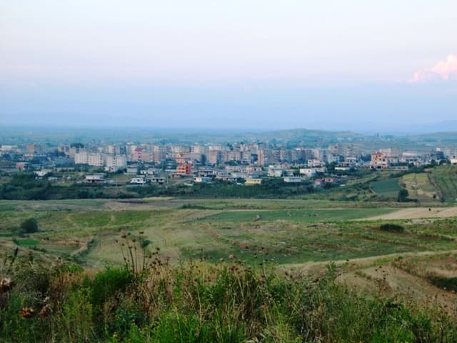 Modern apartment buildings and houses in Patos showcasing beautiful real estate properties