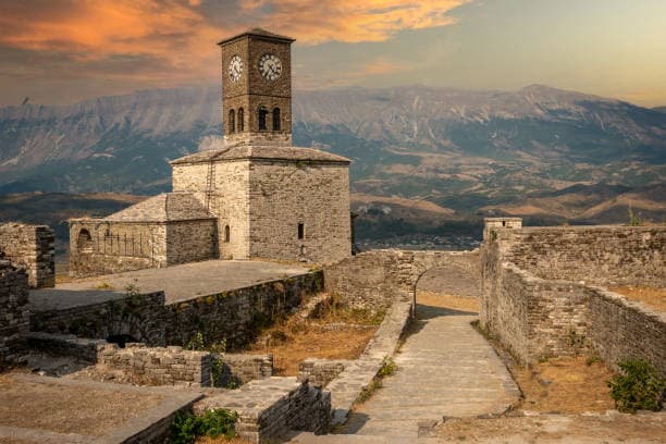 Modern apartment buildings and houses in Gjirokastër  showcasing beautiful real estate properties