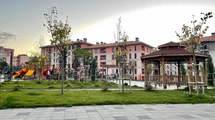 Modern apartment buildings and houses in Laç  showcasing beautiful real estate properties