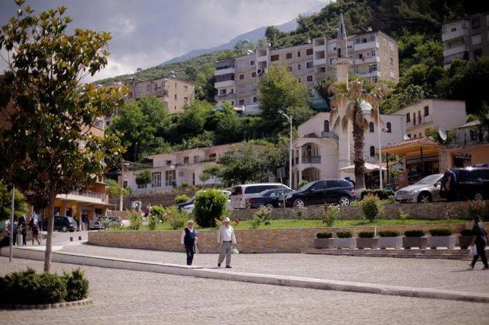 Modern apartment buildings and houses in Poliçan  showcasing beautiful real estate properties